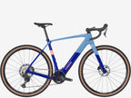Blue and black bicycle with 'Trek' branding on a white background