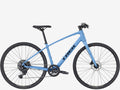Blue bicycle with 'Trek' branding on a white background