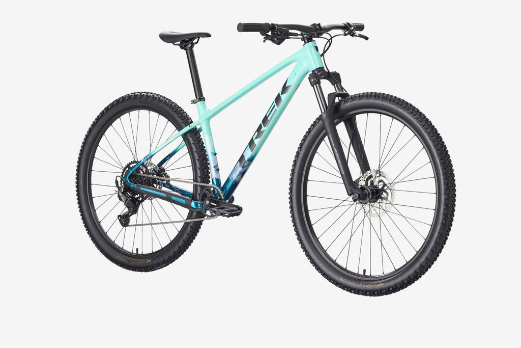 Mountain bike with turquoise frame and black components on a white background