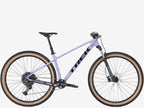 Purple Trek bicycle on a white background