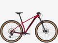 Red mountain bike with black components on a white background