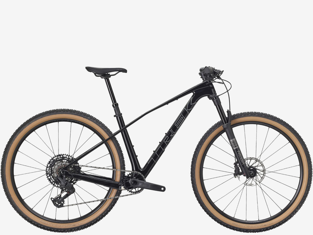 Black mountain bike with brown tires on a white background