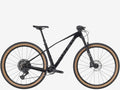 Black mountain bike with brown tires on a white background