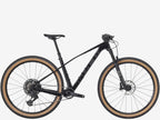 Black mountain bike with brown tires on a white background