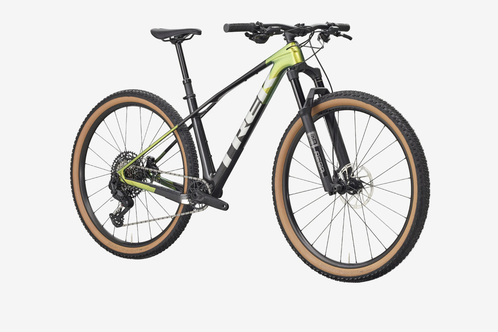 Mountain bike with black frame and green accents on a white background