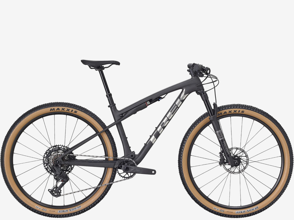 Black mountain bike with tan tires on a white background