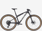 Black mountain bike with tan tires on a white background