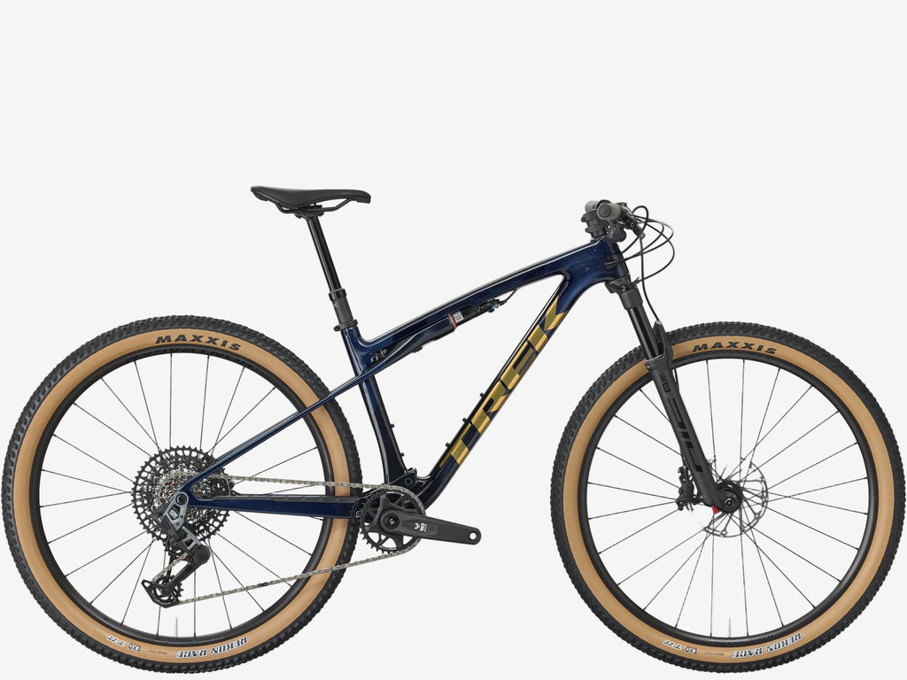 Mountain bike with blue frame and tan tires on a white background