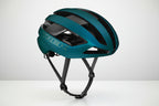 Teal bicycle helmet with 'Trek' branding on a white background