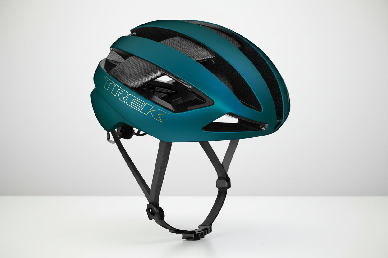 Teal bicycle helmet with 'Trek' branding on a white background